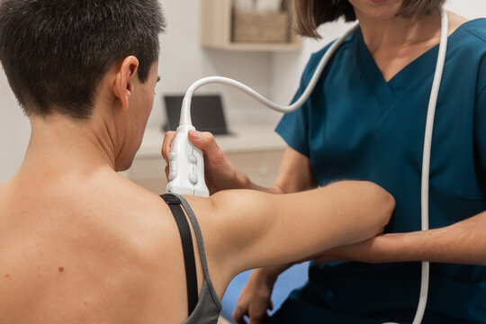 Medical professional performing an ultrasound on a patient's shoulder