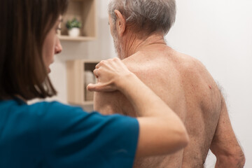 Elderly man receiving physical therapy at home