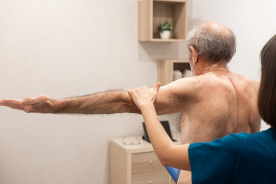 Physical therapy session with elderly male patient