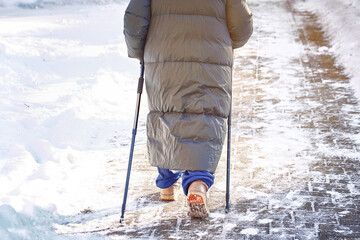 Senior woman practicing nordic pole walking, active lifestyle. Woman trekking with walking sticks...