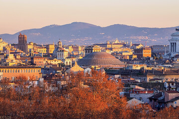Roof top view of Rome historical center and the dome of Pantheon at golden hour. City skyline as...