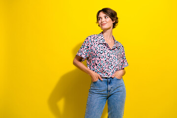 Portrait of stunning minded person put hands pockets look empty space brainstorming isolated on yellow color background