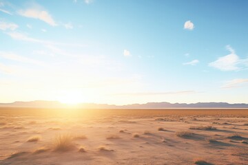 sun setting behind desert plateau