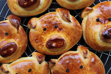 freshly baked golden yellow pretzels with a pig face	
