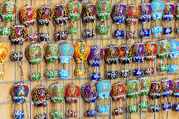 Handmade ceramics magnets in form of colorful hot air balloon displayed at street shop. Typical...