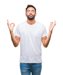 Adult hispanic man over isolated background relax and smiling with eyes closed doing meditation gesture with fingers. Yoga concept.