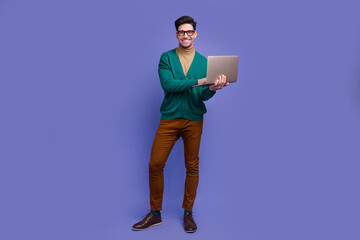 Full length photo of attractive successful man wear stylish clothes use modern device netbook macebook isolated on violet color background