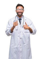 Adult hispanic doctor man drinking glass of water over isolated background happy with big smile doing ok sign, thumb up with fingers, excellent sign