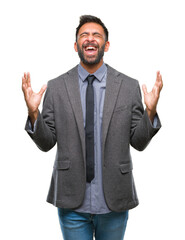 Adult hispanic business man over isolated background celebrating mad and crazy for success with arms raised and closed eyes screaming excited. Winner concept