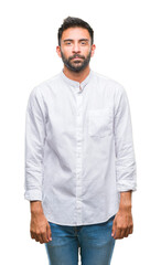 Fototapeta premium Adult hispanic man over isolated background with serious expression on face. Simple and natural looking at the camera.