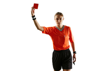 Serious young woman, football referee in uniform showing red card as dismissal symbol against white...