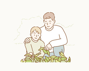 My son and father are looking at the plants