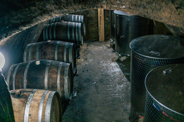 Traditional wine cellars with barrels, casks and stainless steel wine tanks