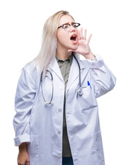 Young blonde doctor woman over isolated background shouting and screaming loud to side with hand on mouth. Communication concept.