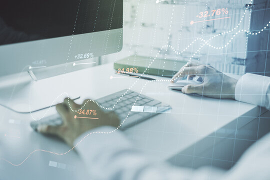 Double exposure of abstract creative statistics data hologram with hands typing on laptop on background, analytics and forecasting concept