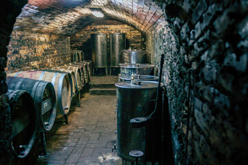 Traditional wine cellars with barrels, casks and stainless steel wine tanks