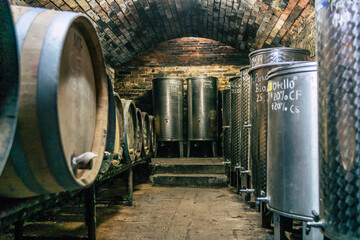 Traditional wine cellars with barrels, casks and stainless steel wine tanks