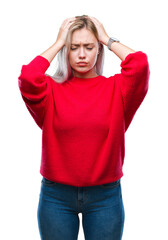 Young blonde woman wearing winter sweater over isolated background suffering from headache desperate and stressed because pain and migraine. Hands on head.