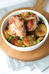 Tasty cooked rabbit with vegetables in bowl on table, closeup