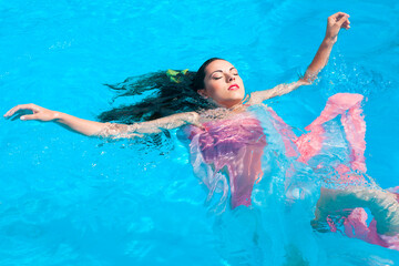 Portrait of a young beautiful woman in water