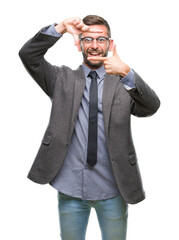 Young handsome business man over isolated background smiling making frame with hands and fingers with happy face. Creativity and photography concept.