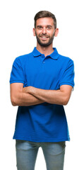 Young handsome man over isolated background happy face smiling with crossed arms looking at the camera. Positive person.