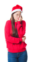 Young Chinese woman over isolated background wearing christmas hat looking stressed and nervous with hands on mouth biting nails. Anxiety problem.