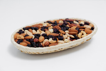various nuts in wooden bowl over white table