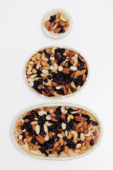 wooden bowls with mixed nuts on white table background