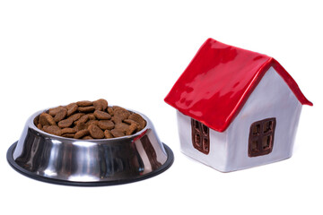adopt a pet toy ceramic house with red roof and metal bowl of dry food on white background