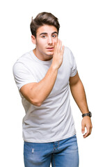 Young handsome man wearing white t-shirt over isolated background hand on mouth telling secret rumor, whispering malicious talk conversation