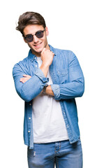 Young handsome man wearing sunglasses over isolated background looking confident at the camera with...