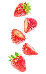 Halved ripe strawberries levitation against white background