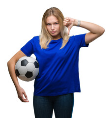 Young caucasian woman holding soccer ball over isolated background with angry face, negative sign showing dislike with thumbs down, rejection concept