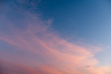 Evening sky with colorful clouds after sunset. Background of clouds melting with vibrant colour in sky