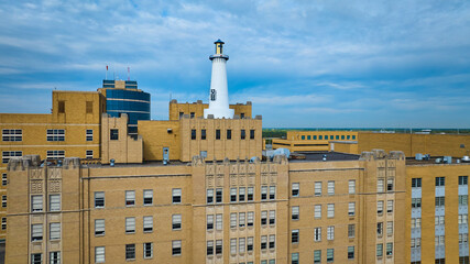 Aerial View of Urban Lighthouse and Vintage Building Against Cityscape - obrazy, fototapety, plakaty