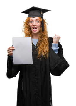 Young redhead woman wearing graduate uniform holding degree screaming proud and celebrating victory and success very excited, cheering emotion