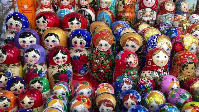 Many colorful Russian wooden souvenirs (matrioshka, nesting dolls) on the counter at a christmas fair.
