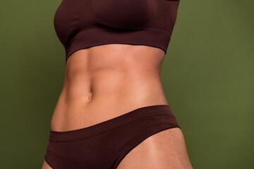 Cropped no retouch photo of amazing ideal figure stomach gym exercises training isolated on khaki color background