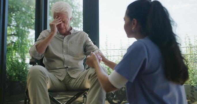 Wheelchair, caregiver and senior man sad over disease diagnosis, healthcare crisis or mobility problem. Empathy, sick client and nurse comfort old patient with disability, depression or medical risk