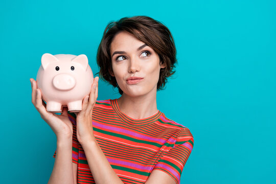 Photo of minded wealthy rich woman dressed trendy clothes look up bank offer credit empty space poster isolated on cyan color background