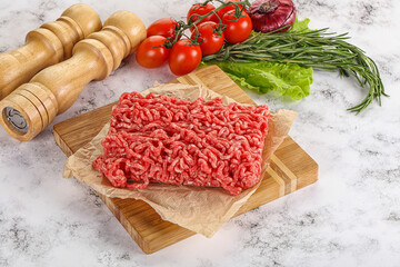 Raw minced beef meat on cutting board