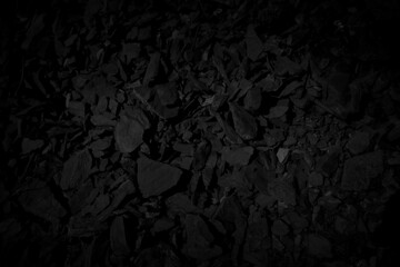 Black stone debris. Rock fragment background.