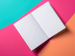 An open book sitting on top of a colorful surface. Notebook mockup on geometric paper pattern.