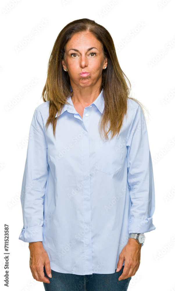 Canvas Prints Beautiful middle age business adult woman over isolated background puffing cheeks with funny face. Mouth inflated with air, crazy expression.