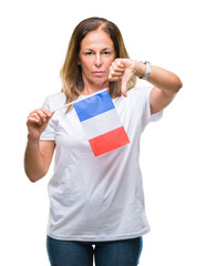 Middle age hispanic woman holding flag of France over isolated background with angry face, negative sign showing dislike with thumbs down, rejection concept