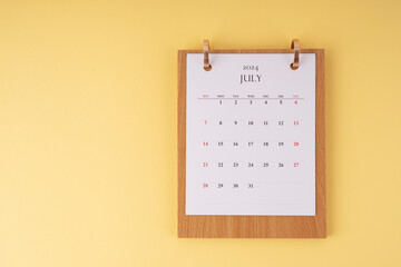 July 2024 desk calendar on yellow background