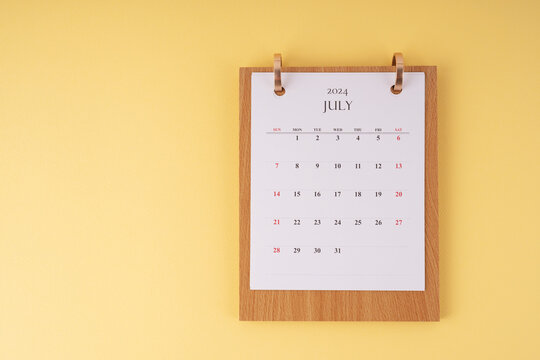 July 2024 desk calendar on yellow background