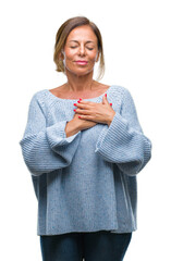 Middle age senior hispanic woman wearing winter sweater over isolated background smiling with hands...