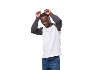 young slender African guy dressed in a black and white sweatshirt posing for the camera